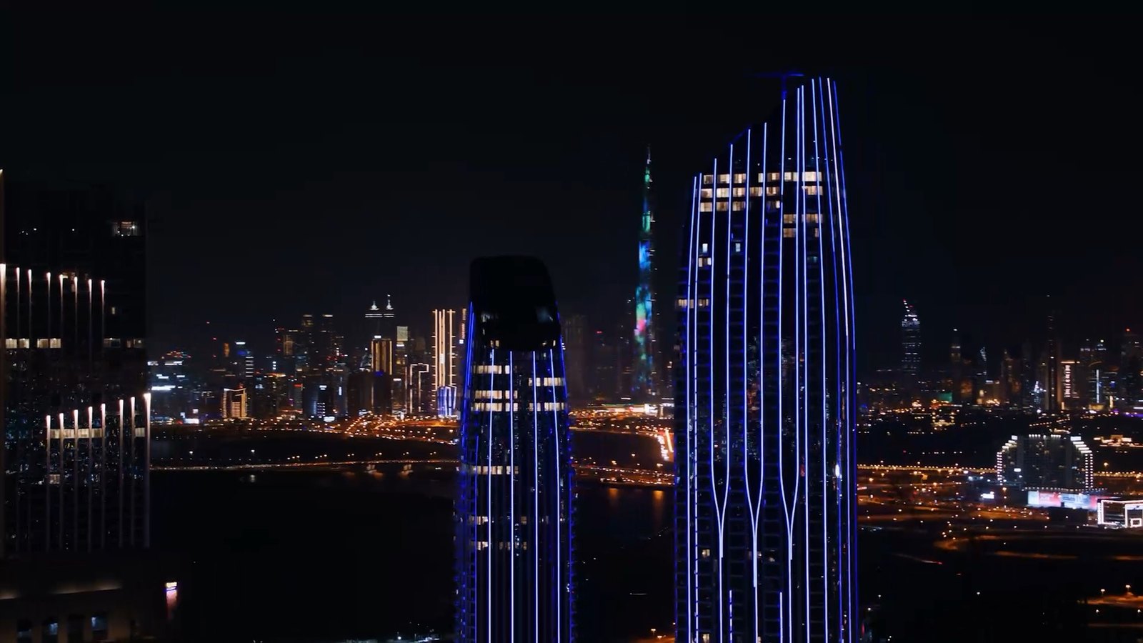 Downtown Dubai skyline illuminated at night, with Burj Khalifa at its centre